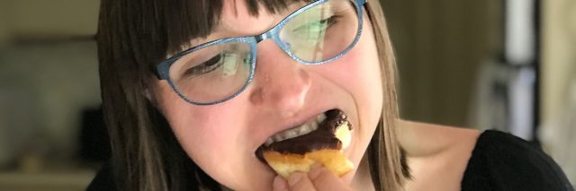 A picture of the writer eating a donut for the first time in three years.