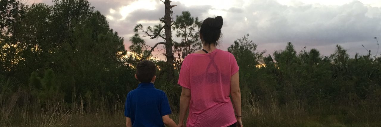 Things I Need as Mom of a Child With a Disability Back of mother and son holding hands