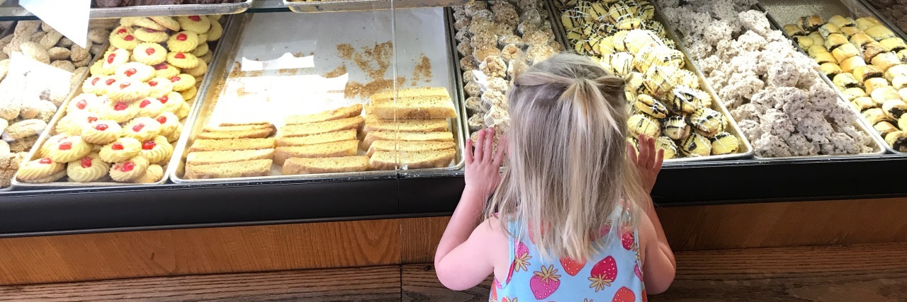 Why My Daughter With a Disability Can Experience Life 'Both Ways' Too  the author's daughter looking at cookies through the store window