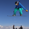 Paralympic athlete Bibian Mentel in mid-air on her snowboard.