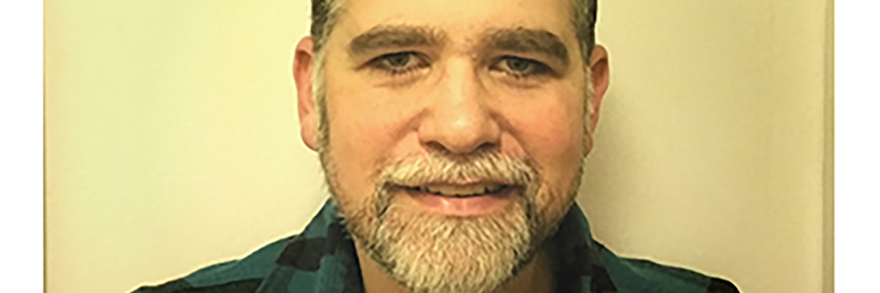 Let's Not Forget Adults With Tourette Syndrome Jason Grant, middle-aged Caucasian man with a gray beard and mustache.