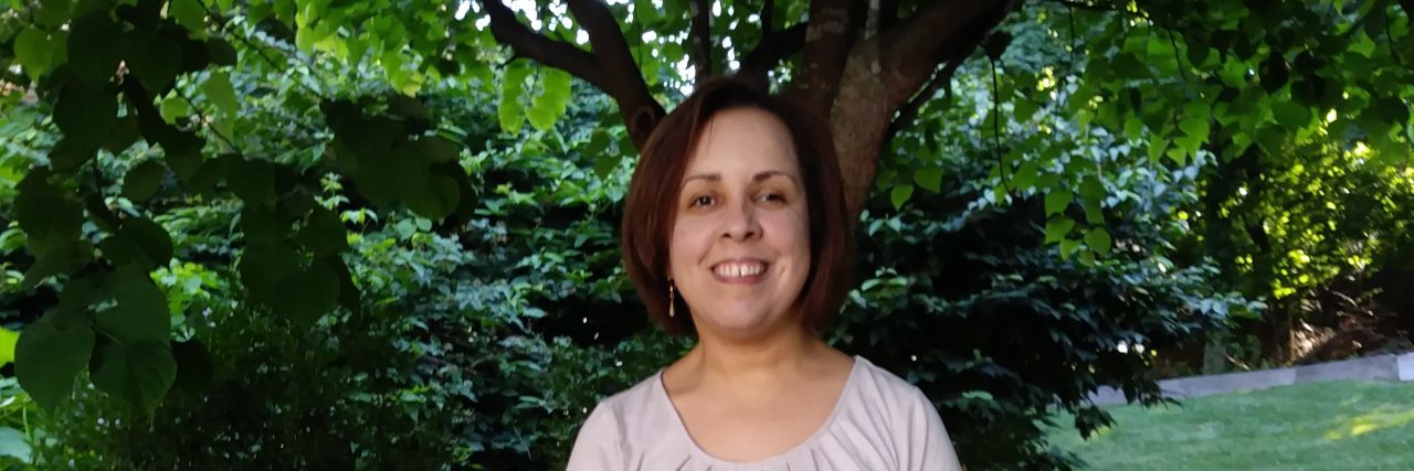 The Bright Side of My Cerebral Palsy Juana Ortiz standing outdoors.