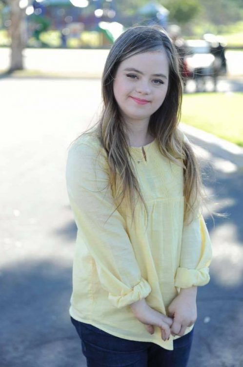 Megan wearing yellow short posing for camera