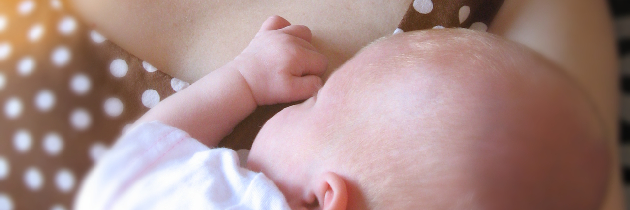 How My Daughter With a Disability Has Brought Me a Deeper Joy Mother holding baby in her arms while baby sleeps