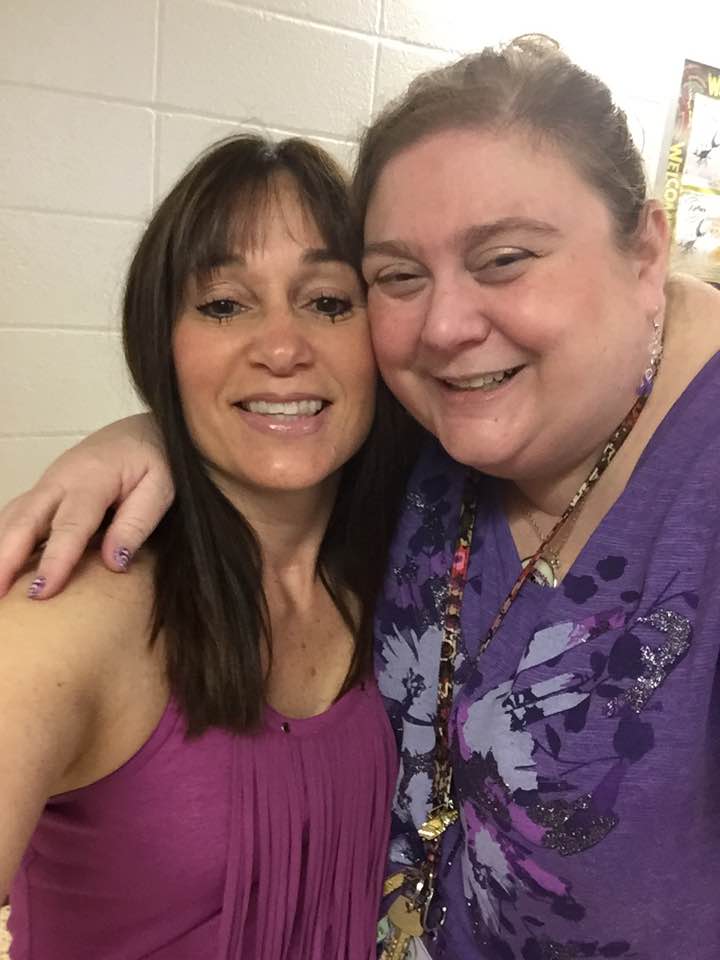 two women wearing purple shirts