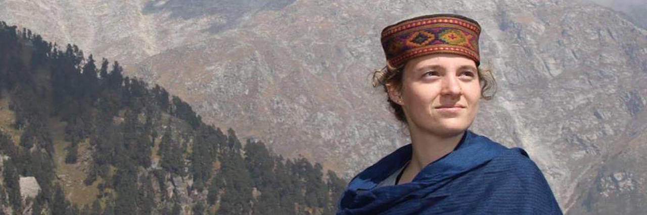 When Anxiety Took Over After My POTS Diagnosis A picture of the writer, mountains standing tall behind her, somewhere in India.