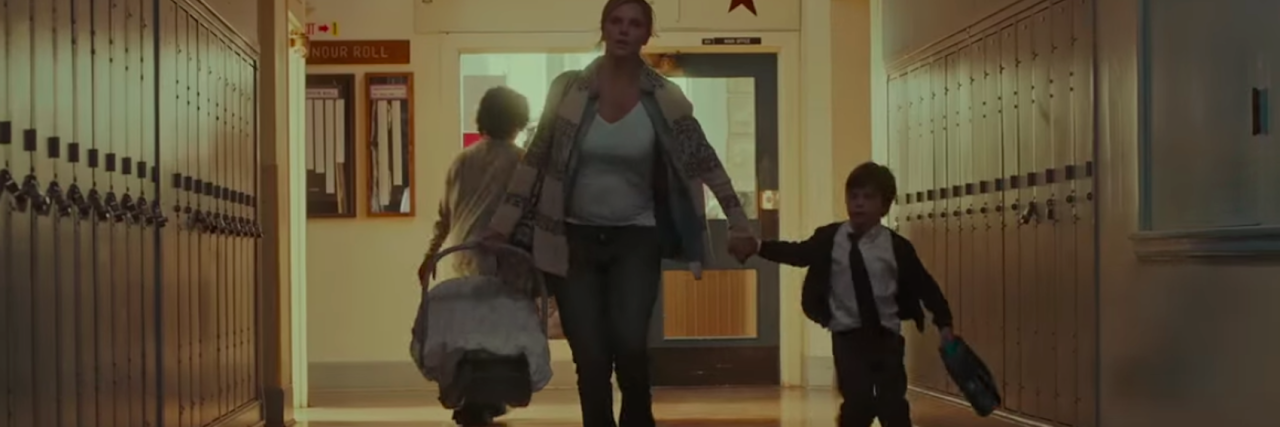 pregnant woman running through school with two children