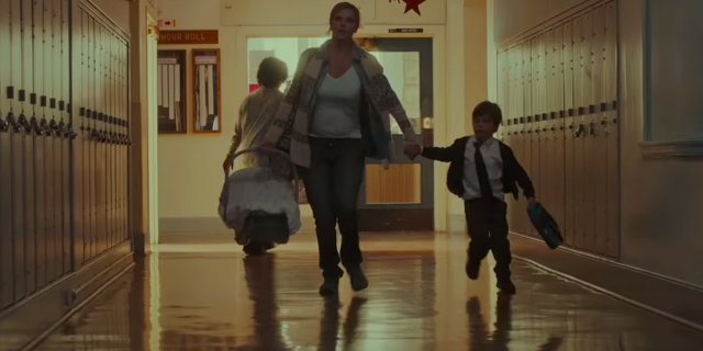 pregnant woman running through school with two children