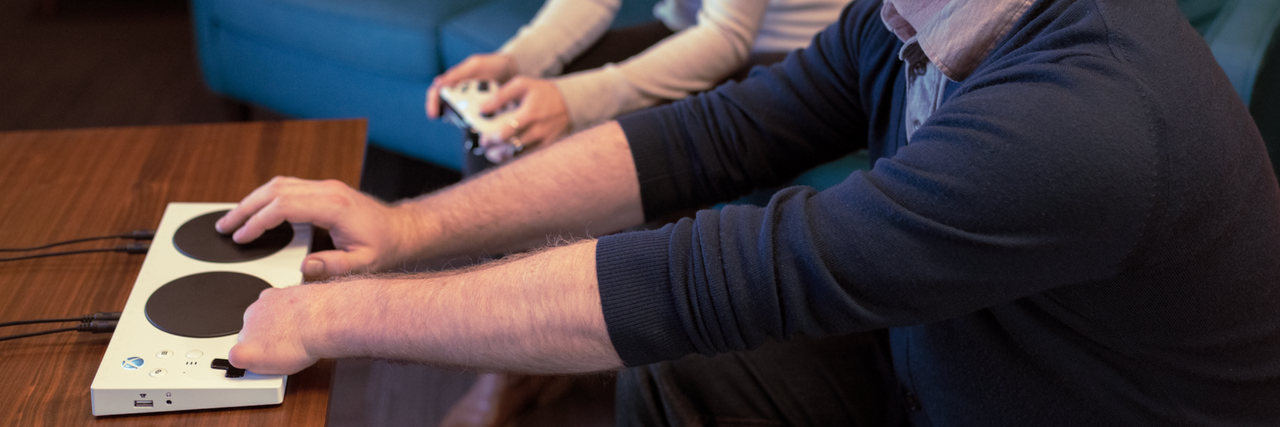 Microsoft Announces Xbox Adaptive Controller for Disabled Gamers Gamer with disability using the Xbox Adaptive Controller