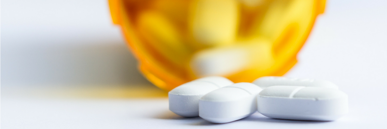 Incoming NRA President Oliver North Blames Ritalin for School Shootings After Santa Fe High School Shooting A pill bottle is on its side with three pills laying on the table outside of the bottle.