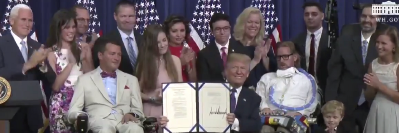 Image of Trump signing right to try bill. He is surrounded by children and adults with terminal illnesses and disabilities.