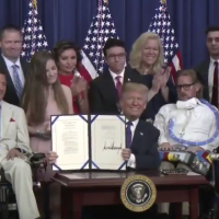 Image of Trump signing right to try bill. He is surrounded by children and adults with terminal illnesses and disabilities.