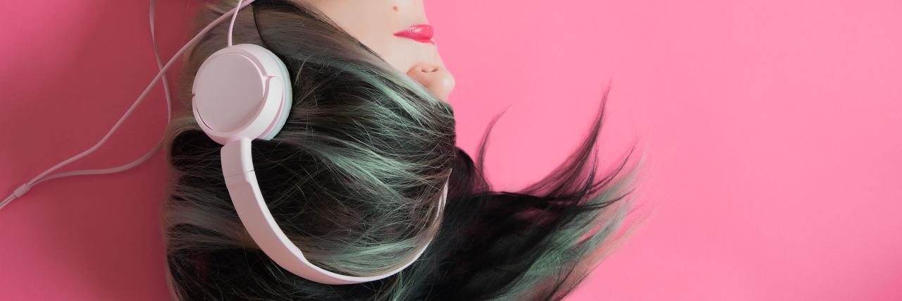 woman in punk listening to music in headphones