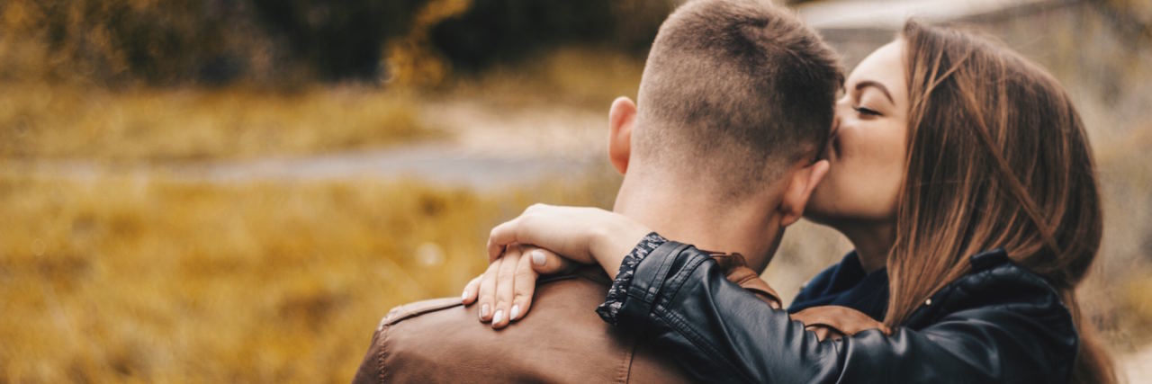 2 Ways I Respond to Relationships as Someone With a Mental Illness couple kissing forehead