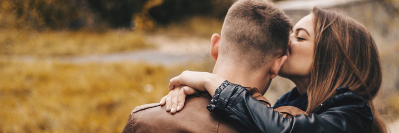 couple kissing forehead