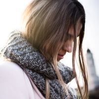 woman wearing a scarf and looking down
