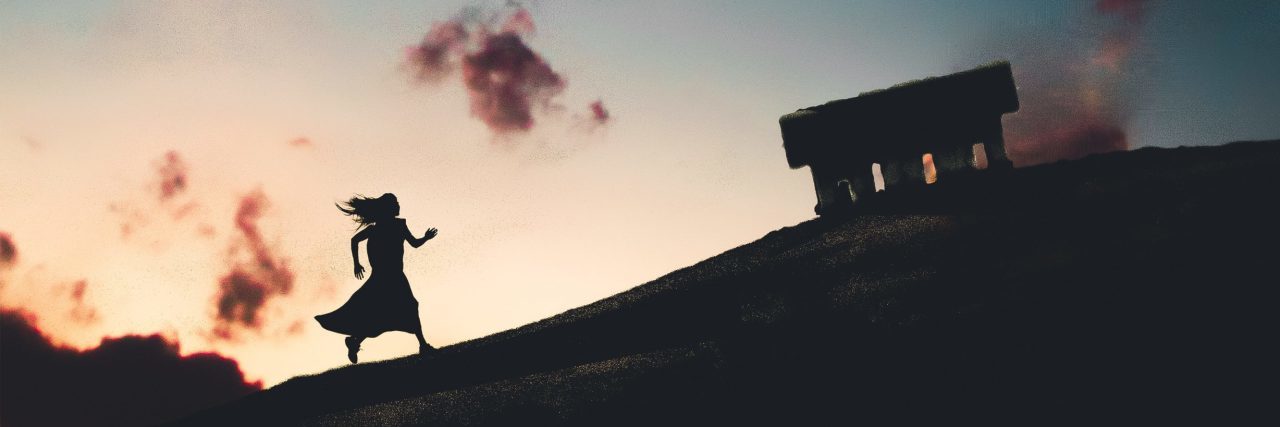 composite image of silhouetted woman walking uphill against cloudless sunset sky and crescent moon