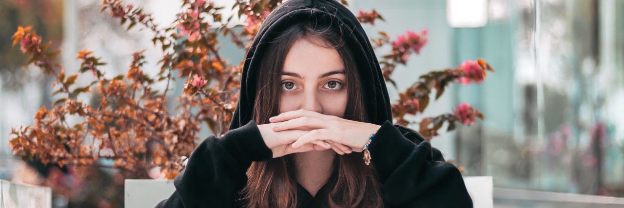 woman with hoodie looking at camera