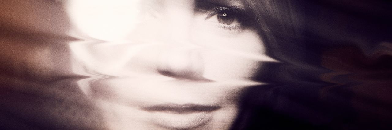 When You Relive Your Childhood Abuse Every Day woman's face blurred by white light