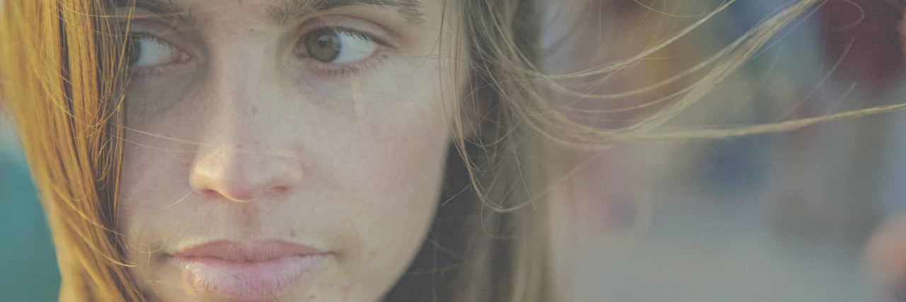 Why People With Chronic Illness Can't Simply 'Push Through' close-up photo of a woman looking away