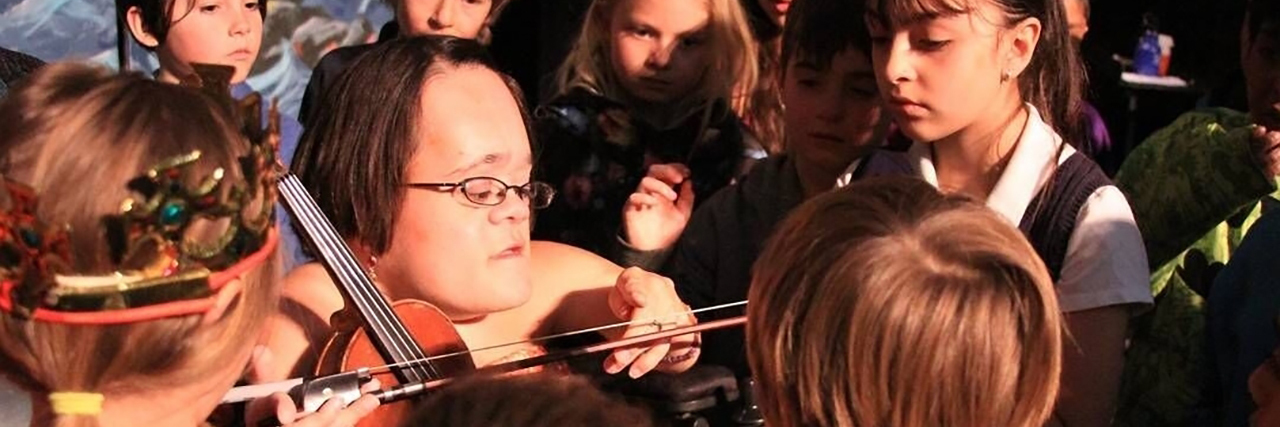 Enrichment: an Inclusive Concept for Self-Help Gaelynn Lea playing violin with a group of young students.