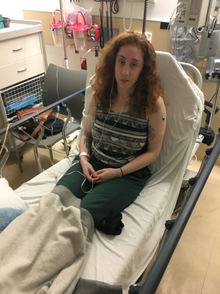 woman sitting in a hospital bed at the emergency room