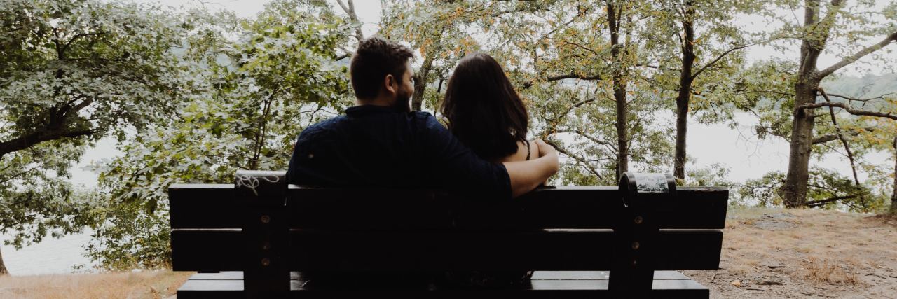 How to Cope With Fibromyalgia Guilt During a Flare-Up man and woman sitting on a bench looking off at the trees