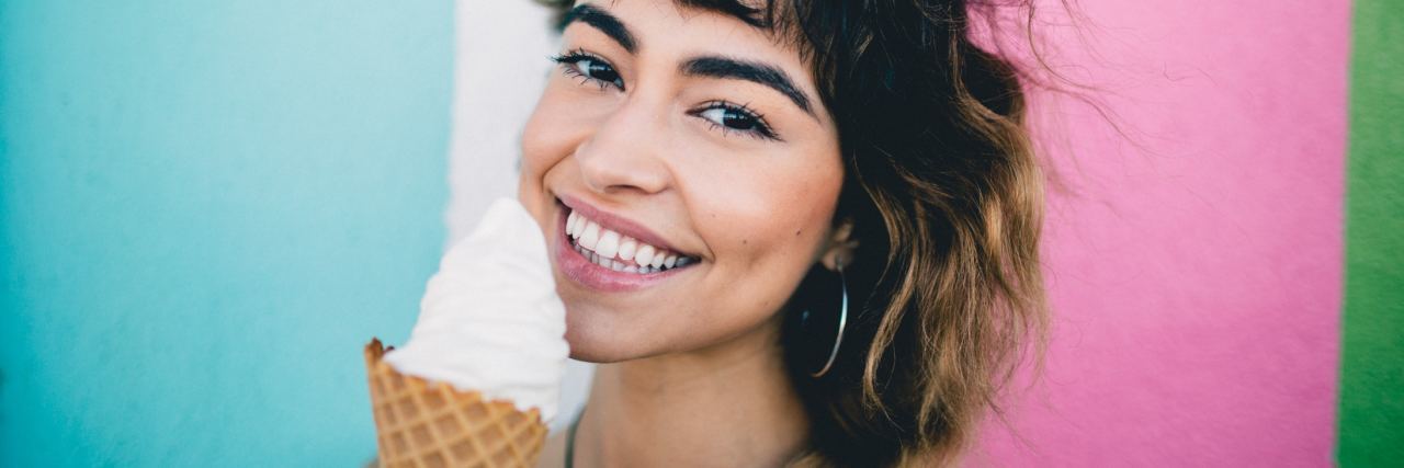 Can You Laugh and Smile and Still Have Depression? Woman smiling while holding ice cream