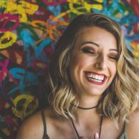 woman laughing against colorful background
