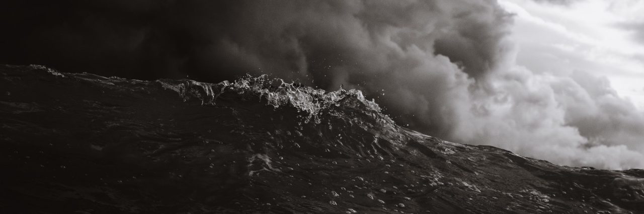 black and white photo of stormy ocean waves and dark clouds