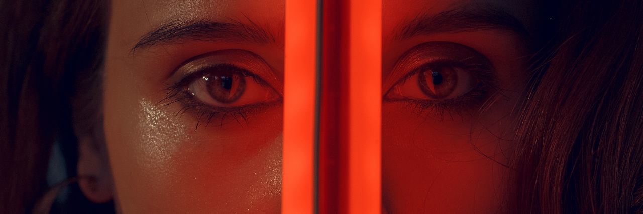 The 'Middle' Part of Eating Disorder Recovery half of woman's face separated by red light