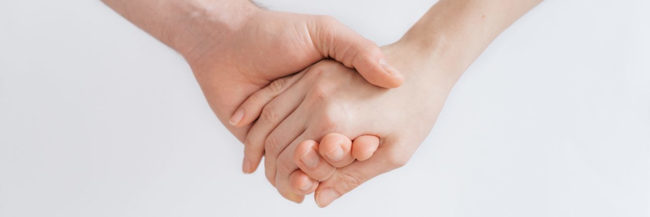 close up of who people holding hands against white background plain