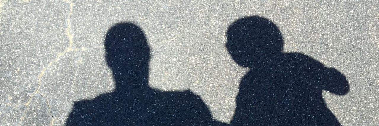 Why I'm Sometimes Defensive as a Parent of a Child With Autism Shadow of father and son holding hands