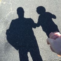 Shadow of father and son holding hands