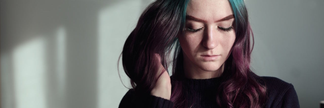 When You Experience 'Reverse' Seasonal Affective Disorder woman with blue hair looking down