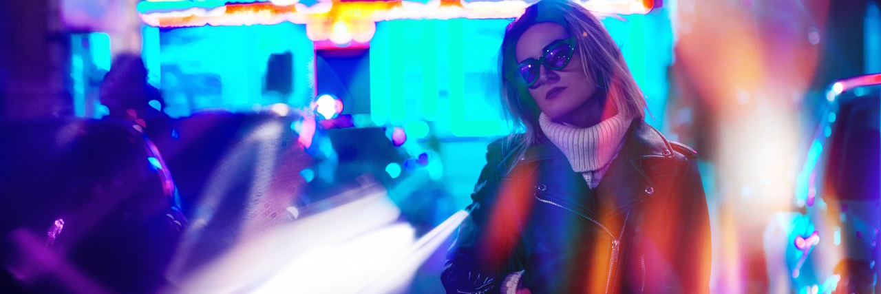 4 Symptoms You May Not Realize Can Be Caused By Anxiety woman neon lights