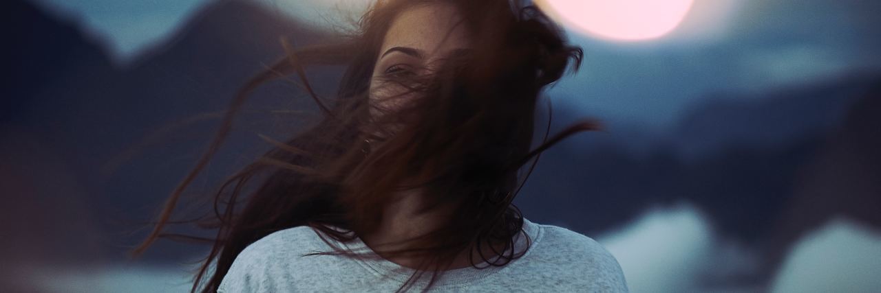 What Life After My Suicide Attempt Is Like woman with dark hair blowing in the wind