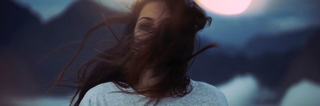 woman with dark hair blowing in the wind