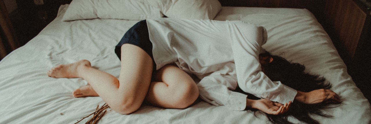 What Healing From Trauma Actually 'Looks Like' woman laying in bed