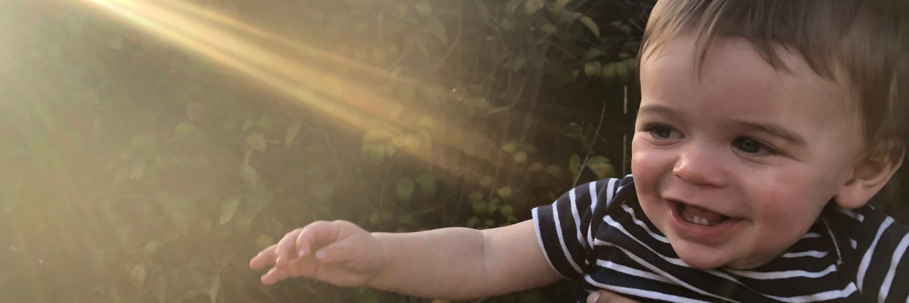 When Your Child Is Somewhere Between 'Sick' and 'Healthy' the author's son smiling, with light shining on him