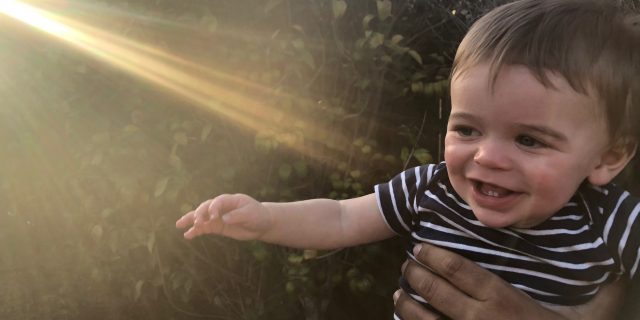 When Your Child Is Somewhere Between 'Sick' and 'Healthy' the author's son smiling, with light shining on him