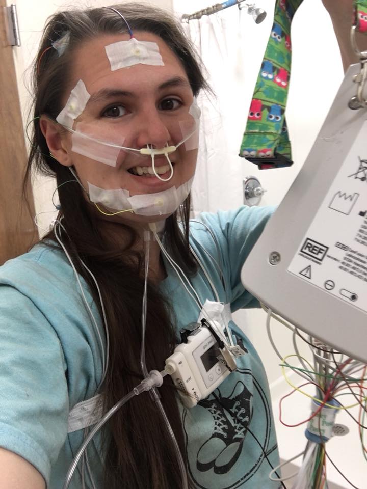 woman attached to wires and monitors for a sleep study