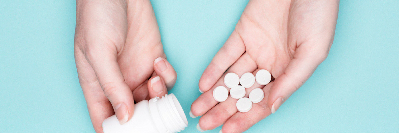 A woman holding pills. Text reads: 2 Antidepressant Side Effects We Don't Talk About