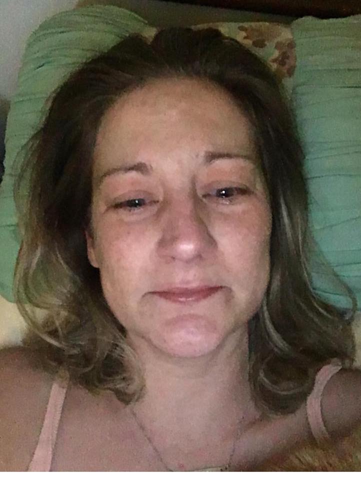 woman lying in bed crying