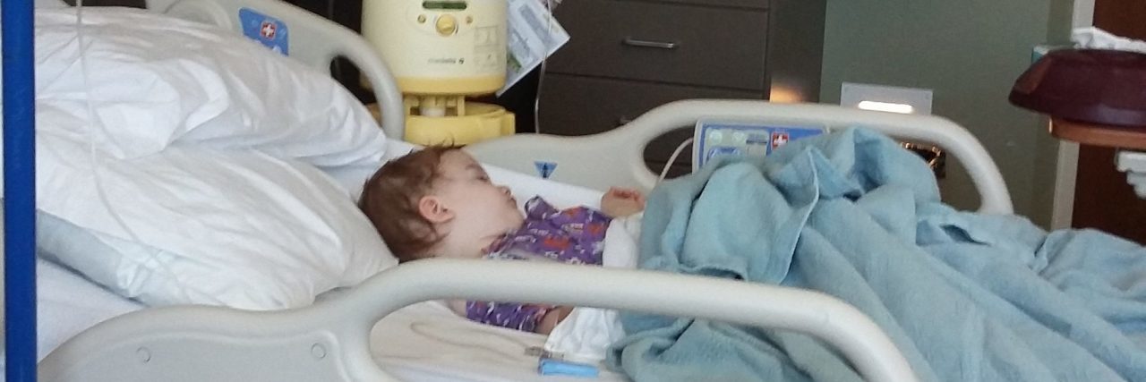 the author's child laying in a hospital bed
