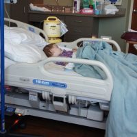 the author's child laying in a hospital bed