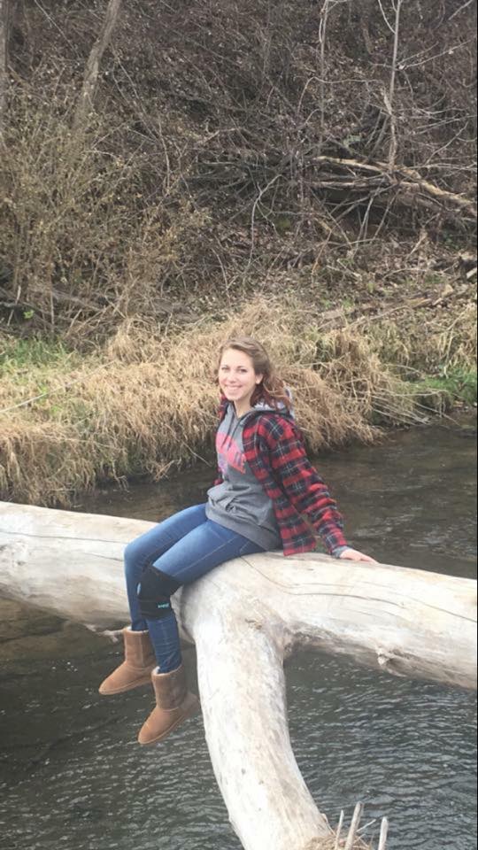 woman sitting on a fallen tree