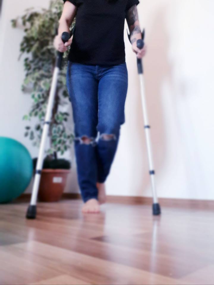 woman walking with crutches