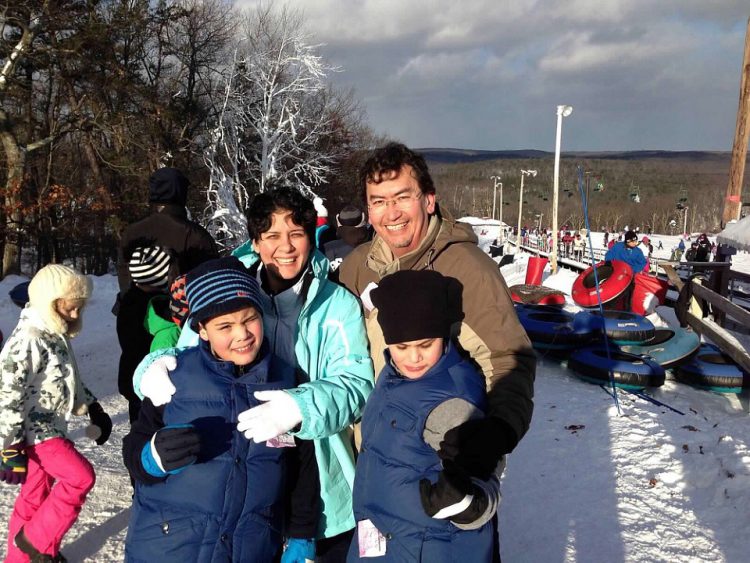 Family picture: mom dad and twin boys at a ski resort