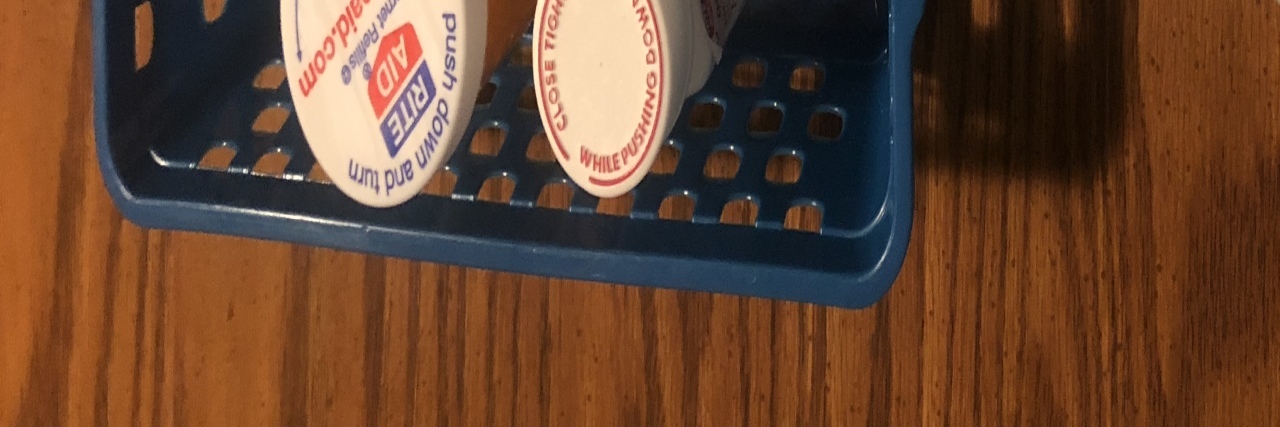 Why I Fear Losing Insurance as Someone With Pre-existing Conditions Lesley's containers of medications.